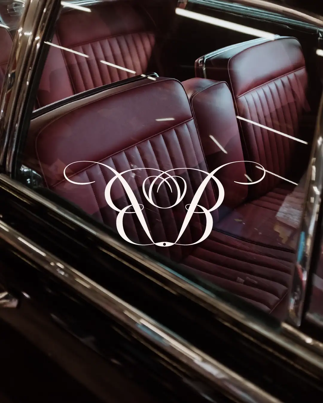 Cream Orto Botanico monogram with overlapping art deco initials on vintage car interior dark burgundy leather, inspirational minimalist luxury design