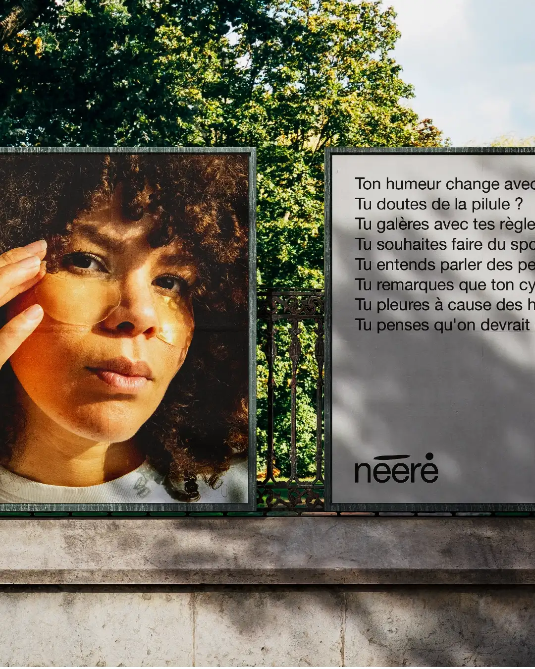 Close-up of two Nééré billboards in urban park: founder Véronique Pirotton portrait left, inspiring questions for women with logo right