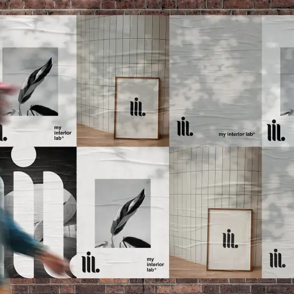 Urban wall covered with varied My Interior Lab posters, blurred person in motion appearing on left side, dynamic street scene