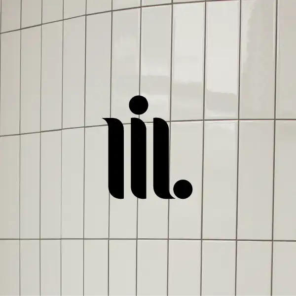 My Interior Lab monogram on glossy cream tile wall, refined minimalist design